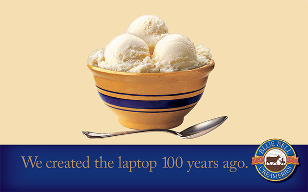 A bowl holding 3 scoops of Blue Bell's vanilla ice cream with a spoon on the side